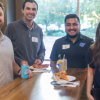 Four event attendees smiling at camera